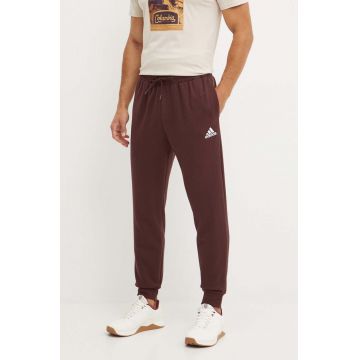 adidas pantaloni de trening Essentials culoarea maro, cu imprimeu, IY9086