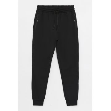 Pantaloni de trening conici cu buzunare cu fermoar