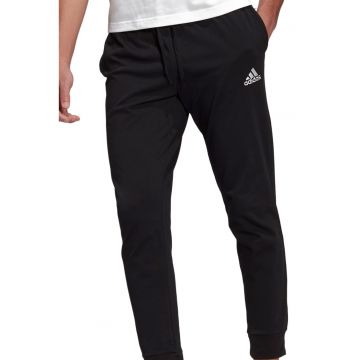 Pantaloni sport cu croiala conica si logo Essentials