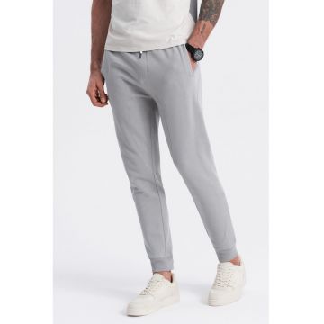 Pantaloni de trening cu croiala conica si snur de ajustare