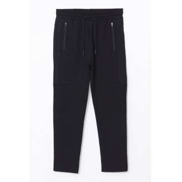 Pantaloni de trening conici cu buzunare cu fermoar